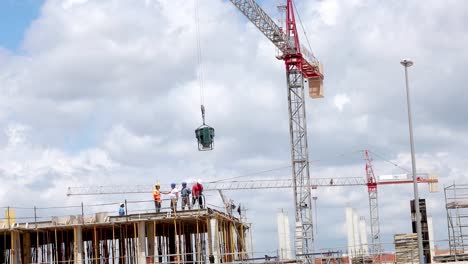 building site workers pour concrete on spanish urbanisation, to build new appartments for holiday makers