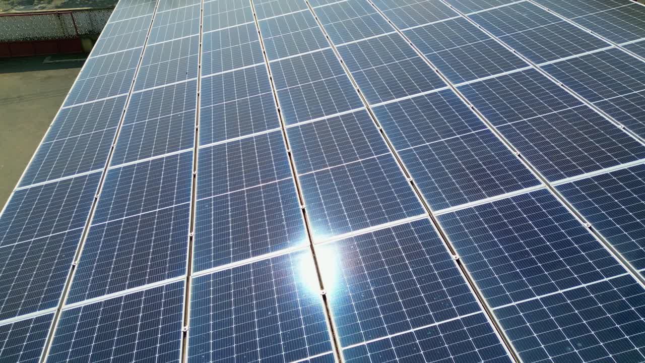 Aerial view of a roof with solar panels and the sun reflecting on them.São Tomé,Africa