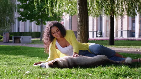 young woman with husky dog in park