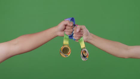 two athletes holding olympic medals