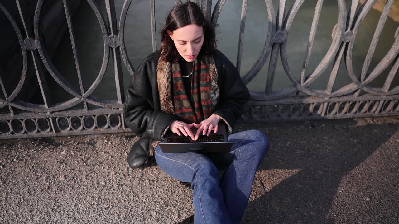 Woman Using Laptop on Bridge