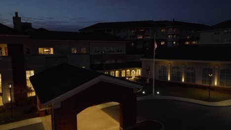 rising aerial establishing shot of entrance of retirement home assisted care building in america