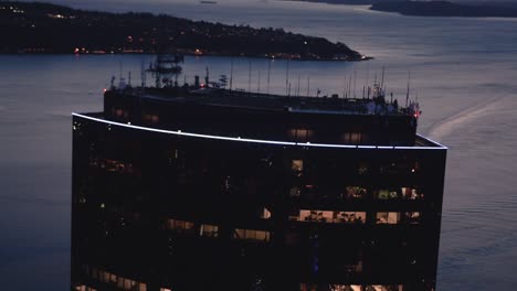 helicopter filming skyscraper building top ocean background