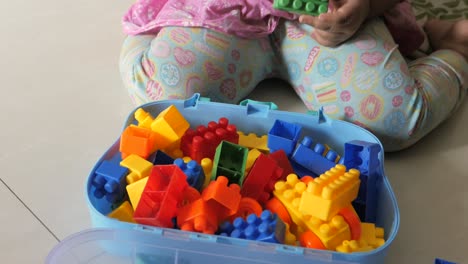 toddler playing with colorful building blocks