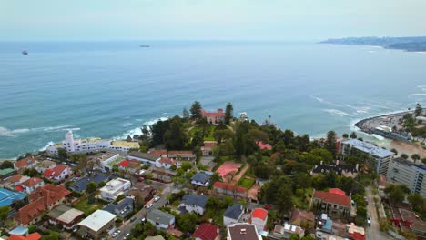 cerro castillo and viña del mar with homes and ocean coastline in chile, aerial view