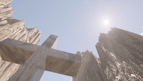 a large cross between huge steep cliffs, with the sun shining above it, 3d animation camera looking upwards to the sky