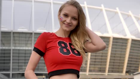 young girl of a blonde football fan of england, smiling, showing like sign, championship concept 50 fps