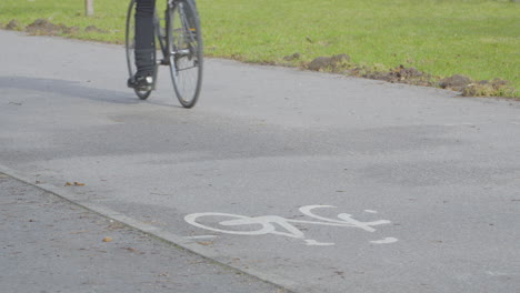 Man-Biking-In-The-Bike-Path-In-Daytime---close-up,-crop-shot