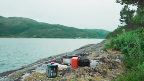 outdoor cooking and food at campsite by the shore of pevika inlet in trondelag, norway