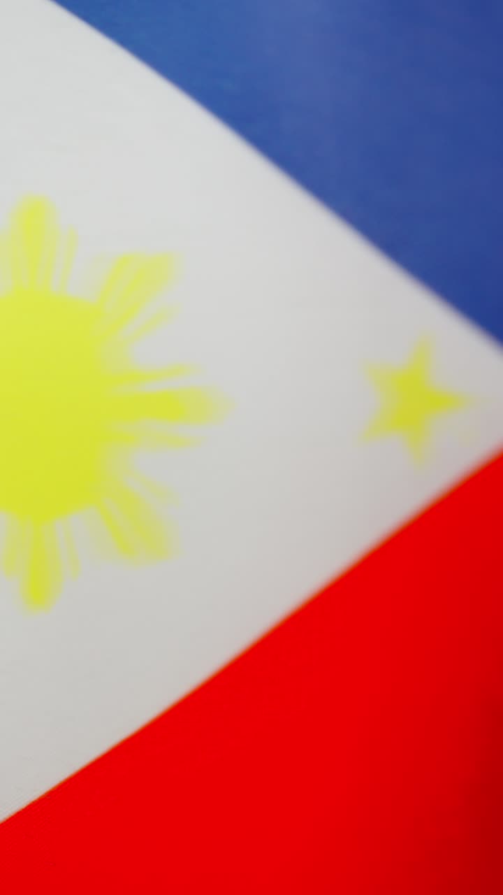 Vertical video of philippine national flag waving by the wind