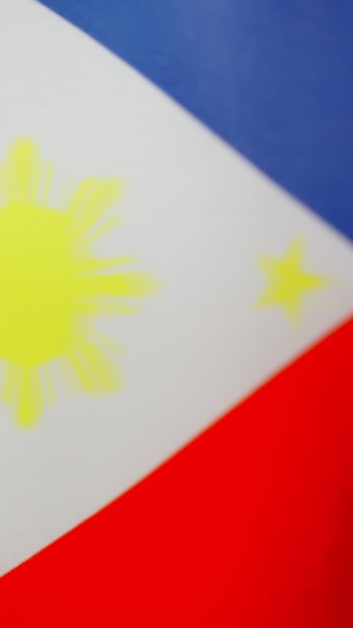 Vertical video of philippine national flag waving by the wind