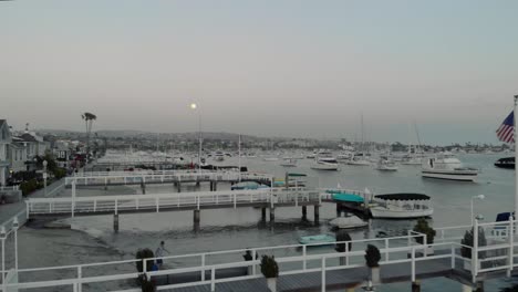 Aerial-fly-over-marina-docks-at-sunset