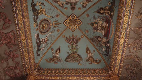 Detailed colorful paintings and carvings on the interior arch of Patuxai Victory Monument in the center of Vientiane, Laos