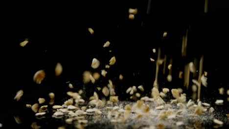 oats falling on black background 4k