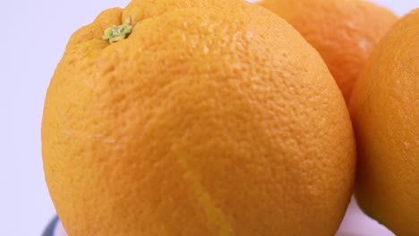 Close-up-fresh-valencia-orange-sliced-with-white-background-shallow-focus-and-slowly-rotating