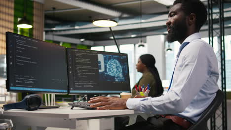 Technician Using Mockup Laptop Next To Office Coworkers Developing Applications
