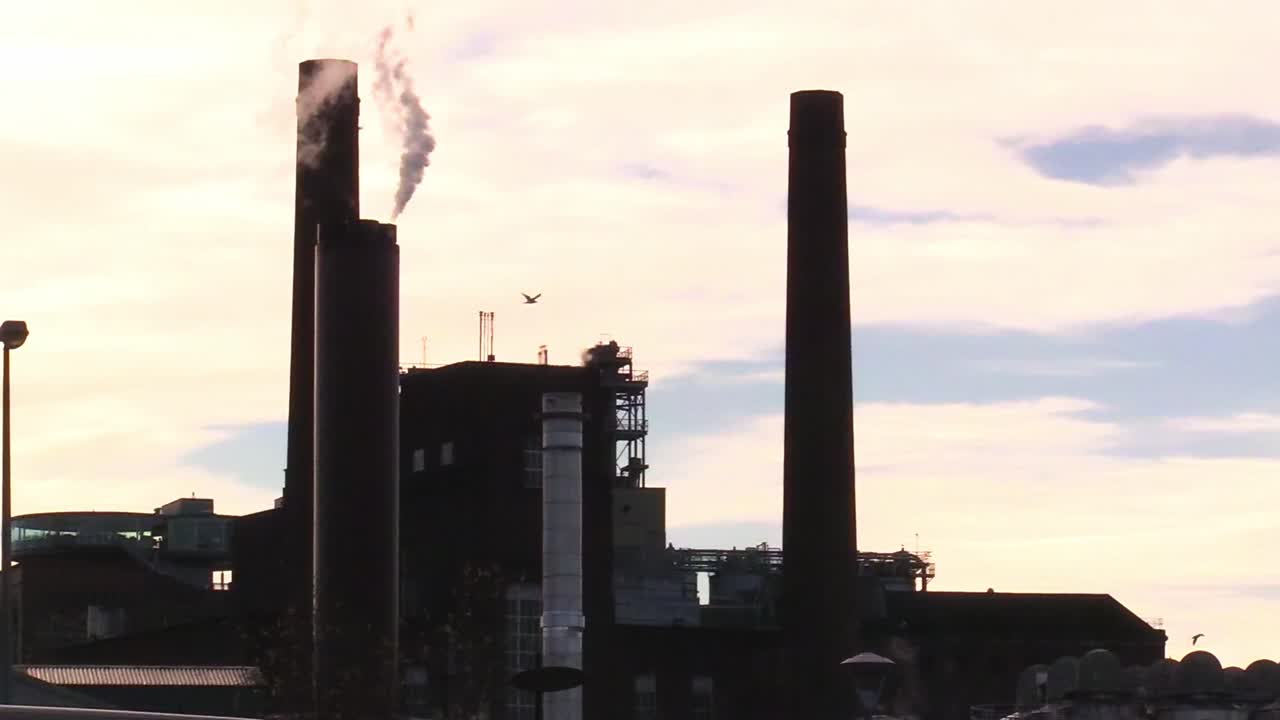 Still shot of smoke coming from Guinness factory chimney on a winter sunny evening.