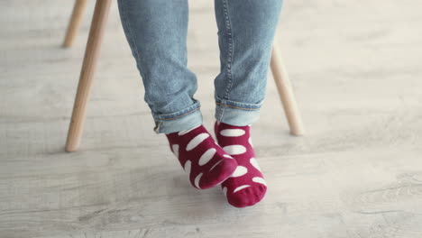 person wearing red polka dot socks and blue jeans