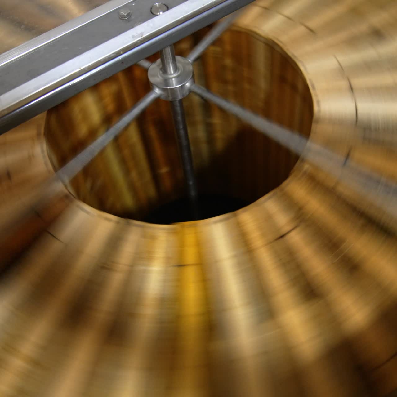 Lots of wooden frames being rotated in the centrifuge machine. Process of honey extraction in special apiary equipment. Close up. Top view