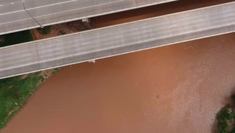 Aerial-of-cars-on-59-South-as-the-pass-over-the-Brazos-River-in-Sugarland,-Texas