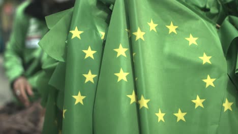 close up of a bunch of green eu flags at a demonstration event