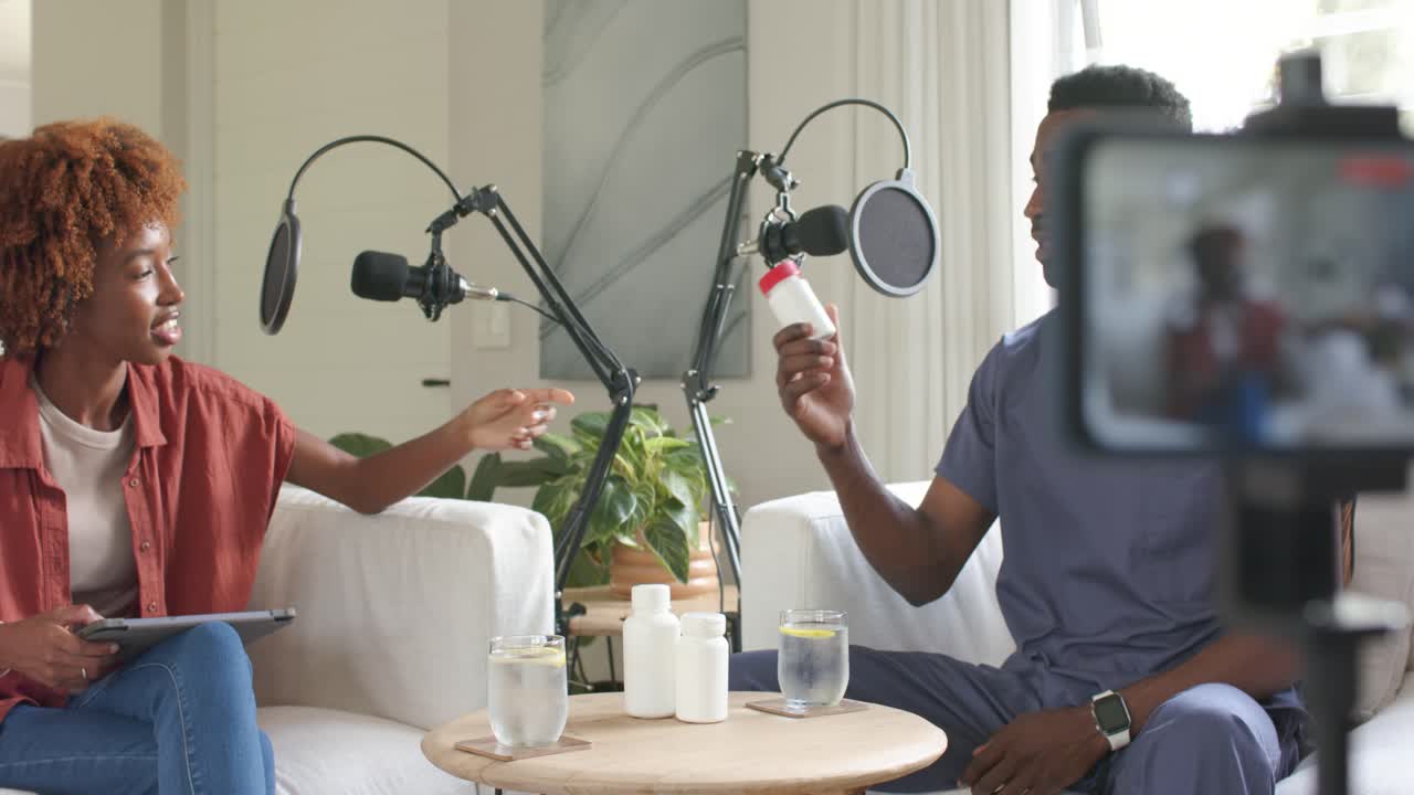 African American hosts on sofa woman offering bottle man in scrubs showing bottle to cam explaining