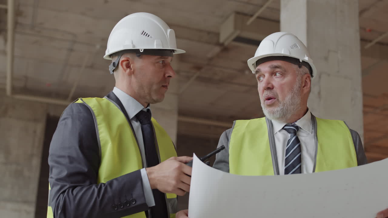 Middle-Aged Construction Workers Discussing Documents