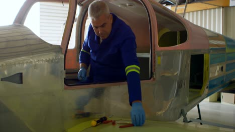 engineer repairing aircraft in hangar 4k