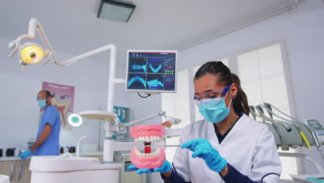 Patient-pov-of-dentist-showing-correct-way-of-cleaning-teeth