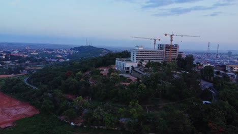 beautiful aerial of the premier hotel under construction with a bird flying in the foreground in ibadan, nigeria