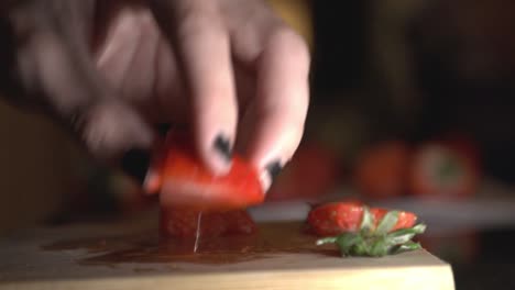 slicing a red and juicy strawberries in the kitchen