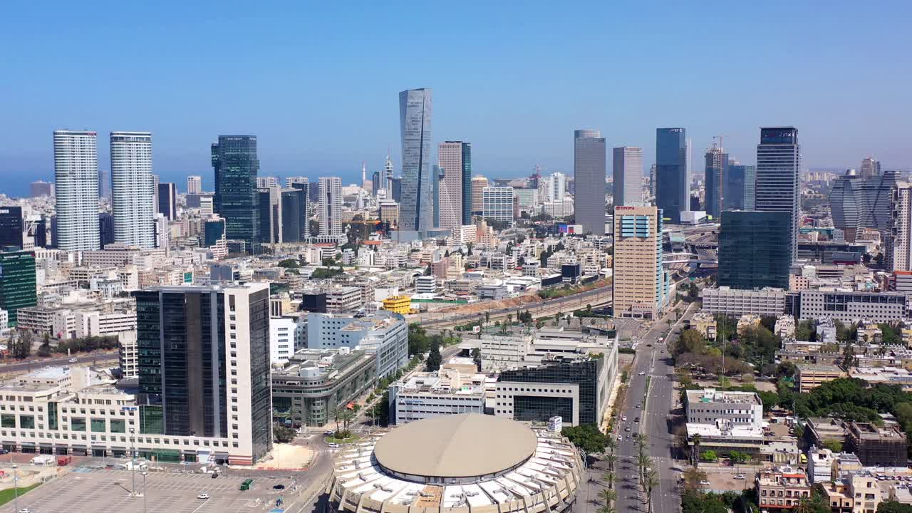Aerial view of a modern city skyline with skyscrapers and urban infrastructure