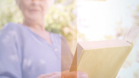 holding book with abstract light animation, elderly person reading outside