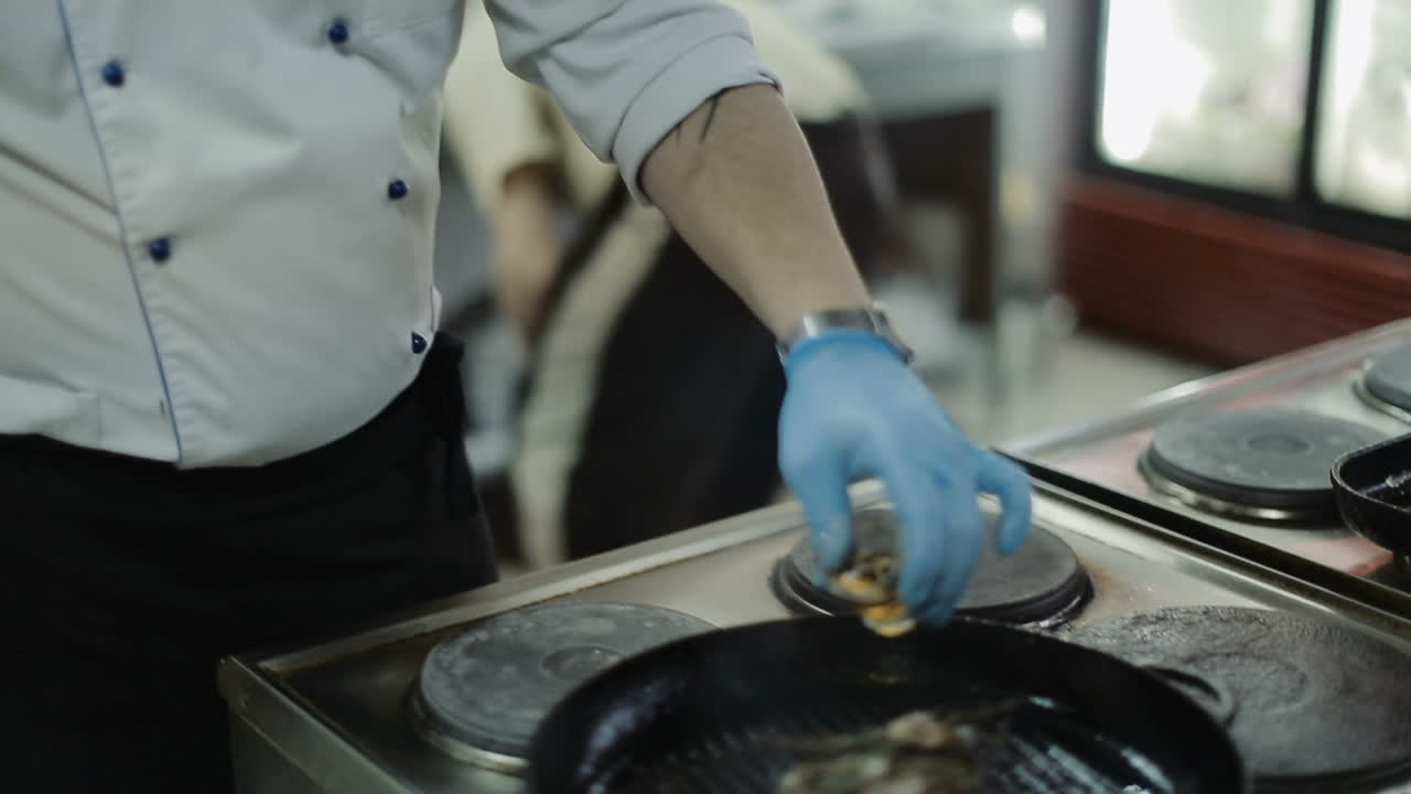 Fry Meat In A Frying Pan. Pork meat steak is frying in pan on restaurant kitchen