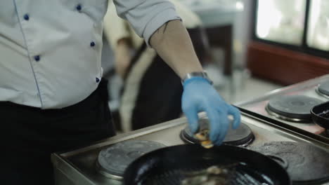 fry meat in a frying pan. pork meat steak is frying in pan on restaurant kitchen