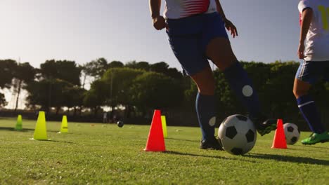 Female-soccer-player-training-with-slalom-on-soccer-field-4k