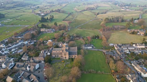 Aerial-footage-of-the-Medieval-village-of-Cartmel-in-the-English-Lake-District-it-has-a-rich-heritage,-and-varied-list-of-activities-for-visitors-and-tourists