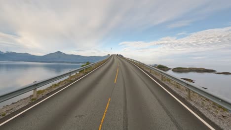 driving a car on a road in norway atlantic ocean road or the atlantic road (atlanterhavsveien) been awarded the title as (norwegian construction of the century).