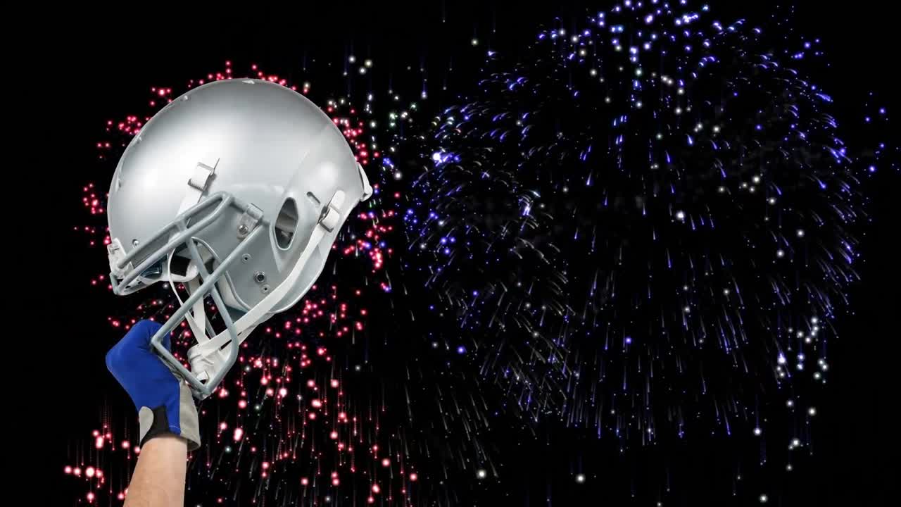 Animation of hand holding american football helmet over fireworks on black background