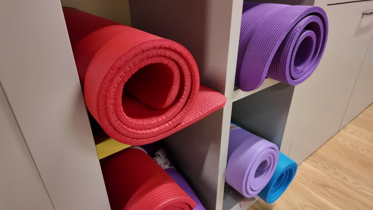 Yoga mats neatly stored on a shelf
