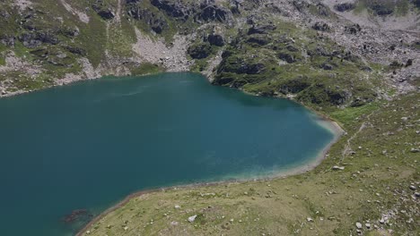 drone footage of one of the fontargente's lakes in the pyrenees mountains