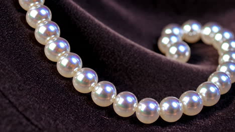 close-up of a pearl necklace on dark fabric