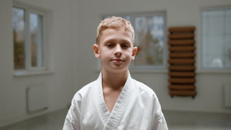 boy in white kimono in martial arts class