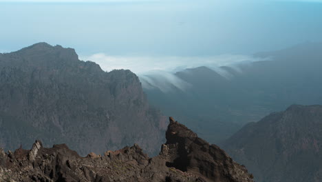 majestic mountain view from roque de los muchachos, showcasing rugged terrain and clouds, timelapse