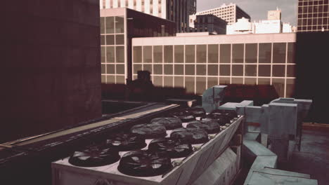 a rooftop view of a cityscape with ac units