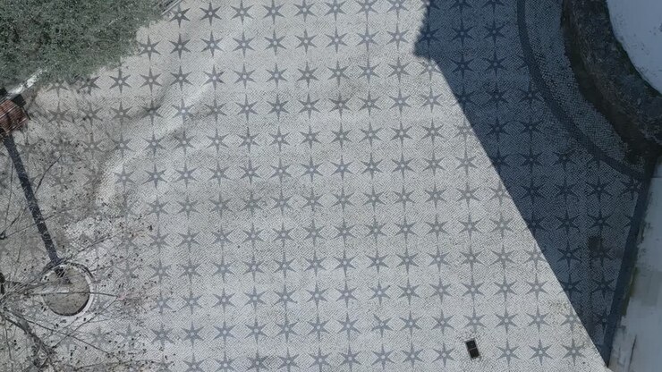 aerial motion view of cobblestone pattern outside church door in Lisbon
