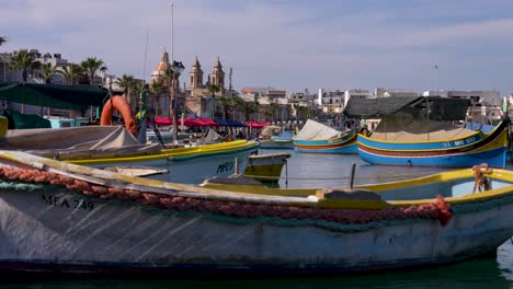 Picturesque-backdrop-of-colorful-fishing-boats,-"Luzzus"-in-Marsaxlokk-on-Malta