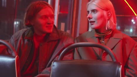 young man and woman chatting in trolleybus