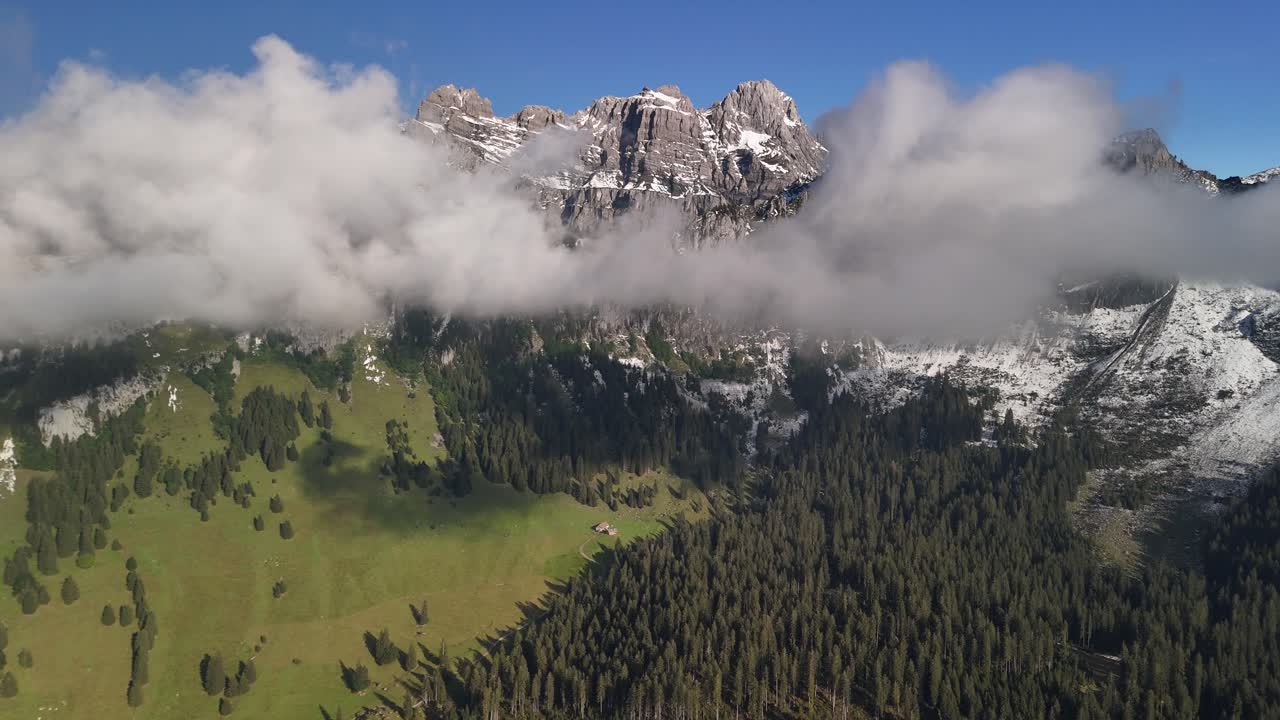 Aerial View of Majestic Swiss Alps Mountains with Clouds and Fog