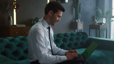 Businessman-having-video-call-on-laptop.-Entrepreneur-waving-hand-at-camera